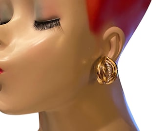 May include: Gold hoop earrings with a row of clear stones set in the center of the hoop.