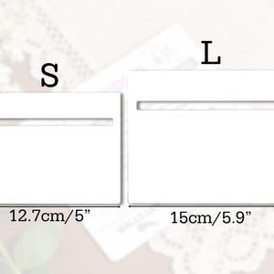 May include: Two white rectangular display stands, labeled "S" and "L", with horizontal slots. The "S" stand measures 10cm/3.9" high and 12.7cm/5" wide. The "L" stand is 12cm/4.7" high and 15cm/5.9" wide.