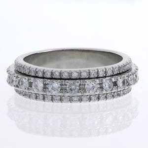 May include: A silver band ring with two rows of small, clear diamonds.