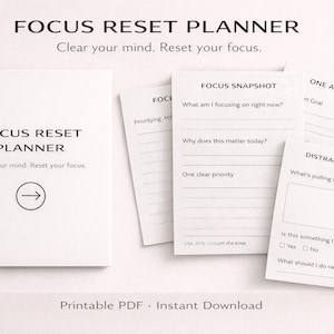 May include: A white Focus Reset Planner with the text "FOCUS RESET PLANNER" and "Clear your mind. Reset your focus." The image also shows loose-leaf pages with prompts for focus and planning.