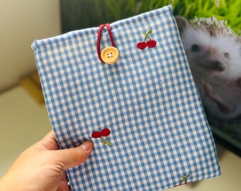 Kratka gingham z haftowanymi wiśniami. Wyściełana kieszeń na książkę. Etui na Kindle Paperwhite. Etui na Kobo Libra Colour, etui na czytnik e-booków.