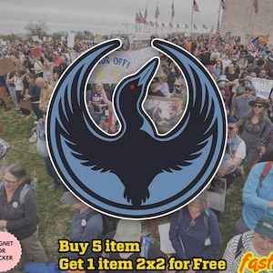 May include: A black and light blue sticker or magnet featuring a stylized bird design with outstretched wings. The image is set against a background of a crowd of people, flags, and signs.