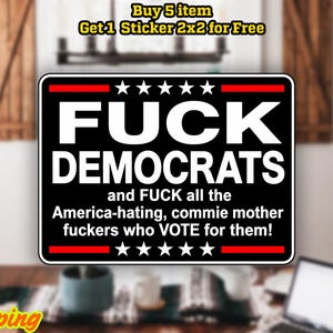 May include: Black rectangular sticker with white text that reads "FUCK DEMOCRATS" and a derogatory statement. The sticker has red and white accents and star graphics. The sticker is labeled as a magnet or sticker.