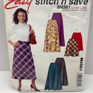 May include: A McCall's M4561 Easy stitch 'n save sewing pattern envelope featuring illustrations of various A-line skirts. The front shows a model wearing a plaid skirt, while the package displays options for solid, floral, and plaid fabric designs.