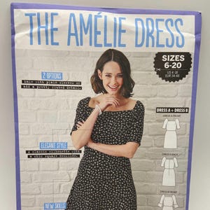 May include: A sewing pattern titled "The Amélie Dress" featuring a woman wearing a black floral print dress with a square neckline. The pattern offers sizes 6-20 (US 4-18, EUR 34-48) and includes options for plain or fluted sleeves.