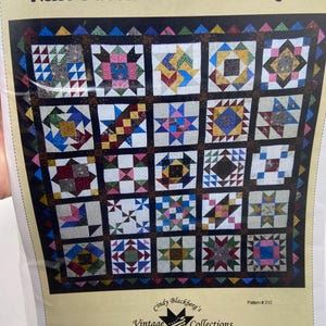 May include: A quilt pattern titled Nine Patch Civil War Sampler by Cindy Blackberg's Vintage Collections, Pattern #310. The design features a grid of twenty-five colorful, multi-patterned square blocks with a dark border and a triangular edge.