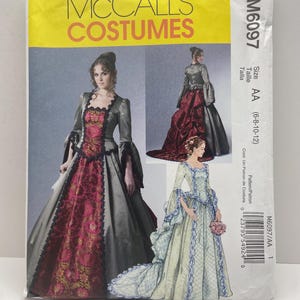 May include: McCall's Costumes pattern M6097. The package features illustrations of historical gowns with long skirts and detailed bodices. The package has the text "MCCALL'S COSTUMES" in yellow and the size is AA (6-8-10-12).