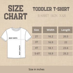 May include: A white toddler t-shirt size chart with measurements in inches. The chart includes sizes 2T, 3T, 4T, and 5-6T, with corresponding width and length measurements. The text "SIZE CHART" is at the top.