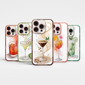 May include: Four different phone cases with colorful illustrations of cocktails. Each case features a different drink: Espresso Martini, Margarita, Aperol Spritz, and Mojito. The cases are white with a black outline and the name of the drink is printed on the bottom.