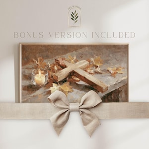 May include: A framed print featuring a wooden cross, a lit candle, and autumn leaves. The artwork has a warm color palette with brown, beige, and yellow tones. The text "BONUS VERSION INCLUDED" is above the frame.