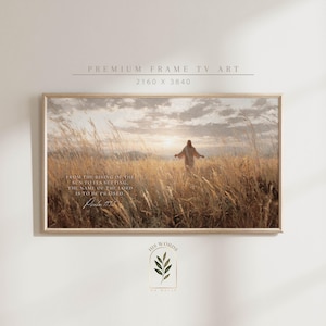 May include: A framed landscape art print featuring a figure walking through a field of tall, golden grass towards a sunset. The artwork includes text from Psalm 113:3. The frame is a light brown color.