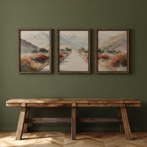 May include: Three framed landscape prints with the words "Ask", "Seek", and "Knock" above a road leading into the distance. The prints are in wooden frames and hang on a dark green wall above a rustic wooden bench.