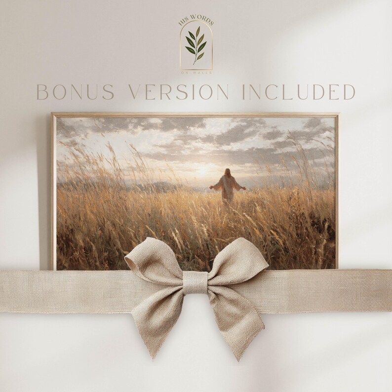 May include: A framed print featuring a serene landscape with a figure in a field of tall grass, bathed in warm sunlight. The text "BONUS VERSION INCLUDED" is above the frame. A beige bow is tied around the frame.