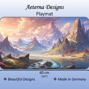 May include: A rectangular playmat by Aeterna Designs featuring a mountain landscape with a lake, rocky terrain, and red trees. The playmat measures 14 inches by 24 inches, with dimensions clearly marked as 35 cm by 60 cm. Text includes Aeterna Designs, Playmat, Beautiful Designs, and Made in Germany.