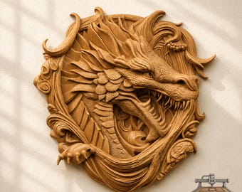 May include: A circular light brown wooden wall carving featuring a detailed dragon head with open jaws, sharp teeth, and textured scales. The dragon is surrounded by swirling, flame-like patterns and organic shapes. The text CNC ROUTER IDEAS is visible.