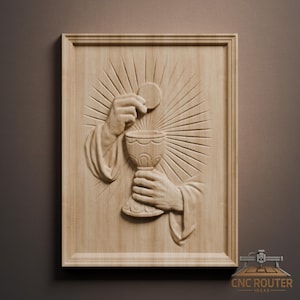 May include: A wooden relief carving depicting a religious scene. The artwork features hands holding a chalice and a wafer, with radiating lines in the background. The piece is framed and has a natural wood finish.