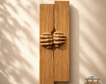 May include: A vertical wall art piece featuring two light brown wooden planks with a natural grain texture. Two carved wooden hands emerge from the center gap between the planks, appearing to grip the edges. The logo CNC ROUTER IDEAS is visible.