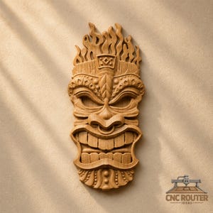 May include: A light brown wooden wall carving of a tiki mask featuring a flame-like top, deep-set eyes, a prominent nose, and a wide, grinning mouth with visible teeth. The surface displays a natural wood grain texture and intricate carvings.