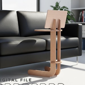 May include: A light-colored wooden laptop stand with a small side table. The stand is next to a black leather couch. The words "DIGITAL FILE" are at the bottom, along with file type icons for PDF, AI, DXF, DWG, SVG, CDR, OBJ, and a user manual.