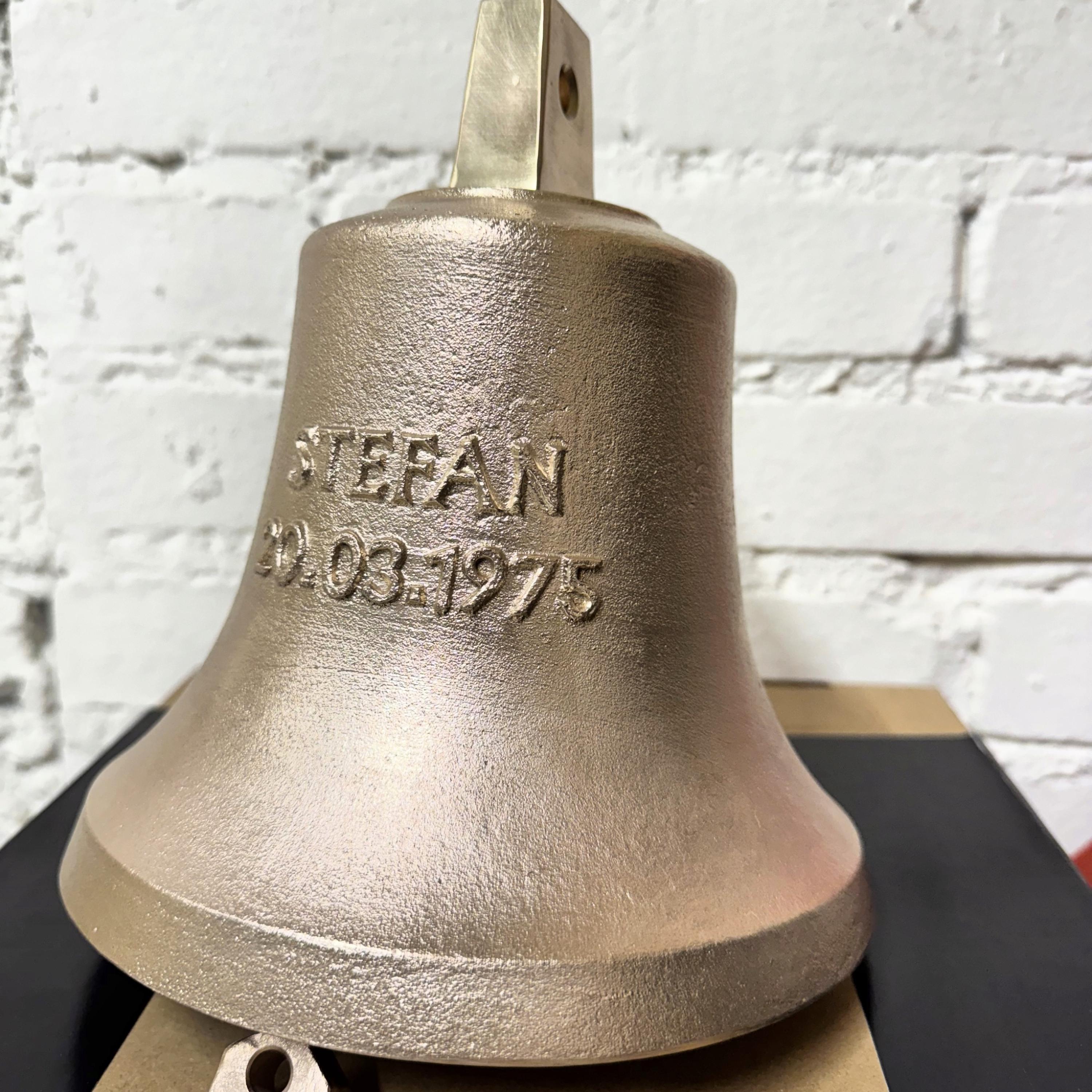 Rough bronze bell with raised lettering