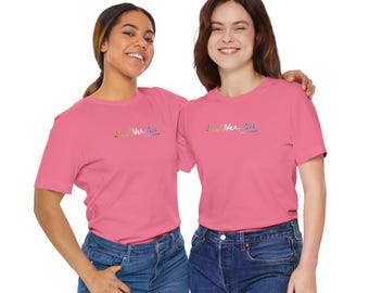 May include: Two people wearing pink t-shirts with the text "Love Her/Yes" in rainbow colors. The shirts are a light pink color and the text is in a rainbow gradient. The people are both smiling and looking at the camera.