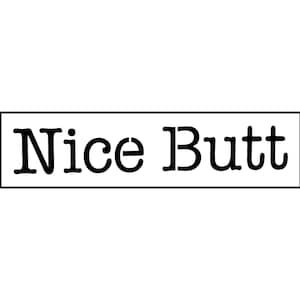 May include: A rectangular sign with the words "Nice Butt" in black, centered within a black rectangular border, set against a white background. The text is in a bold, sans-serif font.