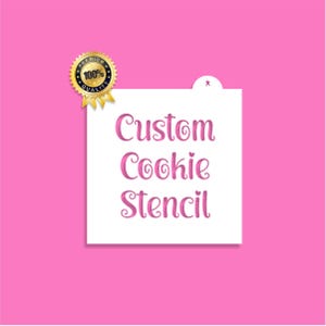 May include: A white square cookie stencil with the words "Custom Cookie Stencil" in pink script. A gold seal with "100% Quality" is in the upper left corner. The background is a solid bright pink.