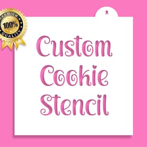 May include: White cookie stencil with the words "Custom Cookie Stencil" in pink cursive lettering.