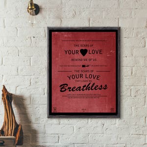 May include: A framed print with a red background and black text. The text reads "Rolling in the Deep... The Scars of Your Love Remind Me of Us They Keep Me Thinking That... We Almost Had It All The Scars of Your Love They Leave Me Breathless I Can't Help Thinking We Could've Had It All You're Gonna Wish You Never Had Met Me Adele 22".