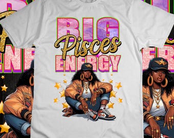 May include: White t-shirt with a pink, green, and gold graphic that says "Big Pisces Energy". The graphic features a cartoon woman with gold jewelry and a gold star on her head.