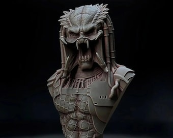 May include: A detailed bust sculpture of a Predator, a fictional alien hunter from the movie franchise. The sculpture is made of a gray material and features a detailed head with a menacing expression, a set of mandibles, and a complex design on the chest.