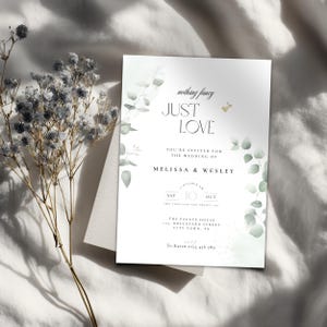 May include: A wedding invitation with the words "JUST LOVE" in elegant script. The invitation features eucalyptus leaf accents and the names Melissa & Wesley. The date is October 10th, with the venue address below.