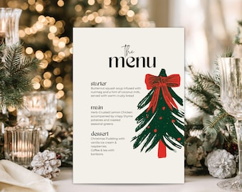 May include: A cream-colored menu card titled The Menu, featuring a hand-drawn green Christmas tree with a red bow. The text lists a starter of butternut squash soup, a main of herb-crusted lemon chicken, and a dessert of Christmas pudding.