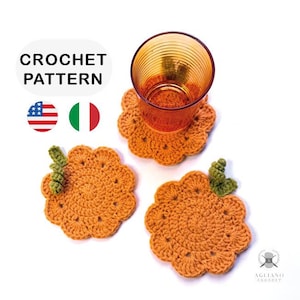 May include: Crochet pattern for pumpkin-shaped coasters. The coasters are orange with green leaf accents. The image includes a glass of orange liquid on one coaster. The text "CROCHET PATTERN" is at the top.
