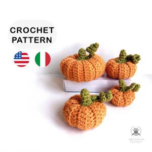 May include: Four crocheted pumpkins in varying sizes, each with an orange body and green stem. The pumpkins are arranged on a white surface. The text "CROCHET PATTERN" is at the top, with the American and Italian flags below.