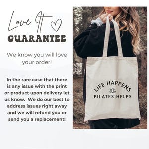 May include: A beige canvas tote bag featuring black text that reads LIFE HAPPENS PILATES HELPS with a small lotus flower icon centered between the two lines of text. The bag has two shoulder straps and is made of a light-colored fabric.