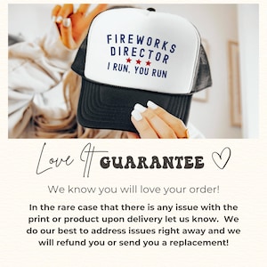 May include: A black and white trucker hat with the text "FIREWORKS DIRECTOR I RUN, YOU RUN" in navy blue. The hat has a white front panel and a black mesh back. Three red stars are between the words "DIRECTOR" and "I".