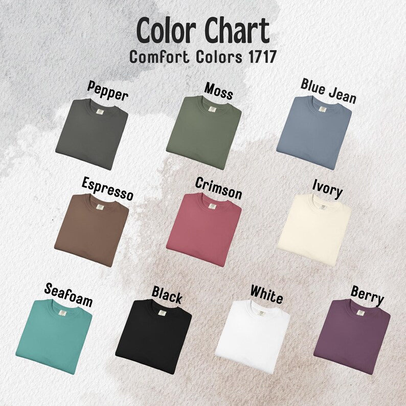 May include: Color chart showcasing Comfort Colors 1717 t-shirts in various hues. Colors include Pepper, Moss, Blue Jean, Espresso, Crimson, Ivory, Seafoam, Black, White, and Berry. Each shirt is neatly displayed, highlighting the range of available shades.