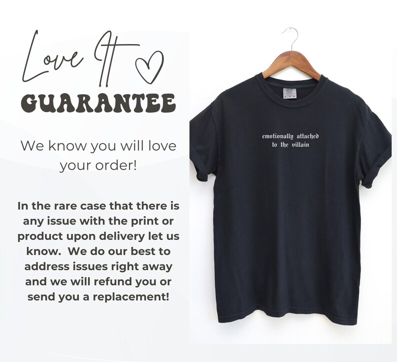 May include: Black t-shirt with the phrase "emotionally attached to the villain" in white lettering. The shirt is hanging on a wooden hanger. Text on the left side reads "Love It Guarantee" and a customer satisfaction statement.
