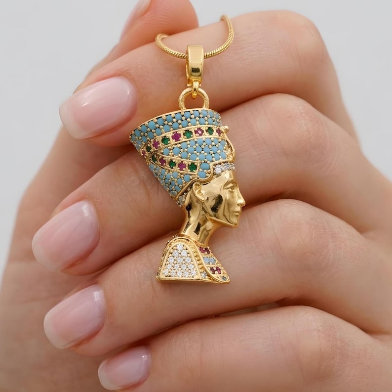 Handmade 24K gold plated Nefertiti necklace adorned with vibrant turquoise red and green gemstones. This intricate Egyptian queen jewelry for women serves as a stunning anniversary gift for her. A high quality spiritual necklace for mom handcrafted for daily elegance and protection.