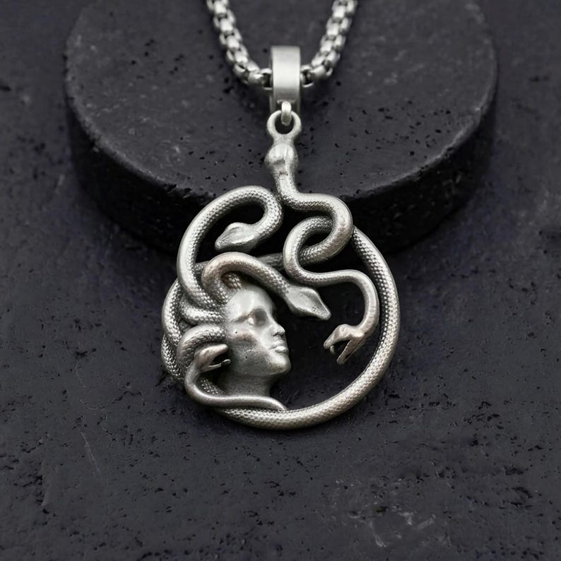 Handmade 18K gold plated Medusa necklace featuring a circular pendant with a detailed relief of Medusa's head and serpents. Available in matte gold, shiny gold, and antique silver finishes. Ancient Greek mythology jewelry, protective snake pendant, unique spiritual gift for her, versatile mythological necklace for everyday wear.