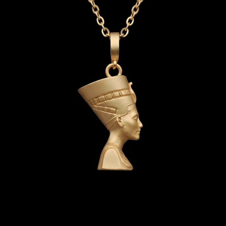 Handmade Nefertiti necklace available in both matte and shiny 24K gold plated finishes. Whether you select the polished or matte gold necklace for women it serves as a stunning anniversary gift for her. These ancient Egyptian necklaces are high quality gifts for mom handcrafted for those who love unique spiritual jewelry.