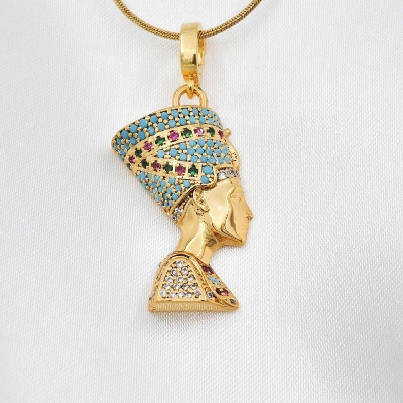 Handmade 24K gold plated Nefertiti necklace adorned with vibrant turquoise red and green gemstones. This intricate Egyptian queen jewelry for women serves as a stunning anniversary gift for her. A high quality spiritual necklace for mom handcrafted for daily elegance and protection.