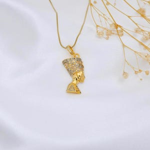 Handmade 24K gold plated Nefertiti necklace adorned with brilliant clear natural zircon gemstones for a dazzling look. This intricate Egyptian queen jewelry for women is a high quality spiritual gift for mom. Perfect as an anniversary gift for her handcrafted for daily elegance and protection with genuine zircon.