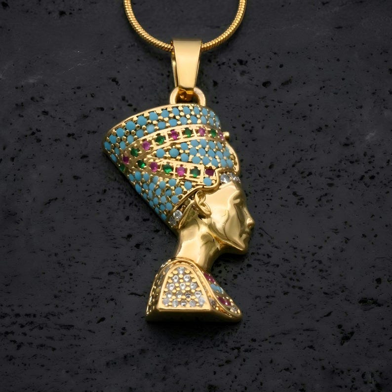 Handmade 24K gold plated Nefertiti necklace adorned with vibrant turquoise red and green gemstones. This intricate Egyptian queen jewelry for women serves as a stunning anniversary gift for her. A high quality spiritual necklace for mom handcrafted for daily elegance and protection.