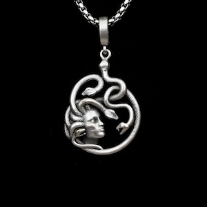 Handmade 18K gold plated Medusa necklace featuring a circular pendant with a detailed relief of Medusa's head and serpents. Available in matte gold, shiny gold, and antique silver finishes. Ancient Greek mythology jewelry, protective snake pendant, unique spiritual gift for her, versatile mythological necklace for everyday wear.
