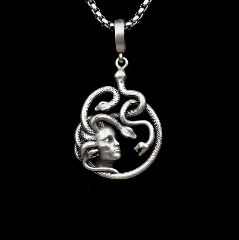 Handmade 18K gold plated Medusa necklace featuring a circular pendant with a detailed relief of Medusa's head and serpents. Available in matte gold, shiny gold, and antique silver finishes. Ancient Greek mythology jewelry, protective snake pendant, unique spiritual gift for her, versatile mythological necklace for everyday wear.