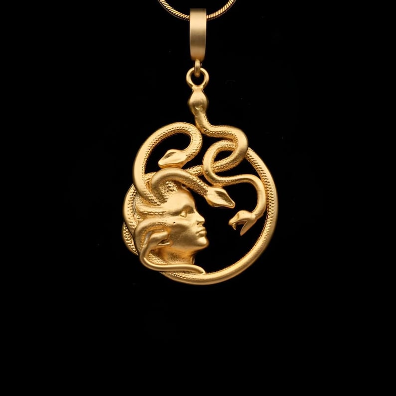 Handmade Medusa necklace in matte gold finish. The circular pendant features a detailed relief of Medusa and snakes. This matte option provides a sophisticated, non-shiny ancient look. Unique spiritual gift for her.