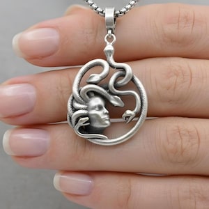 Handmade Medusa necklace in antique silver plated finish. The dark silver tones highlight the intricate details of the snakes and Medusa's face. Bohemian style mythological jewelry, spiritual protector gift.