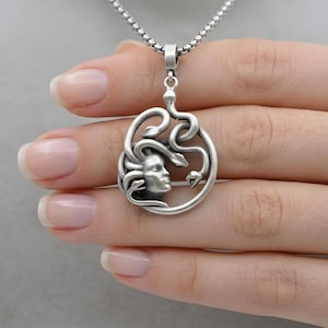 Handmade Medusa necklace in antique silver plated finish. The dark silver tones highlight the intricate details of the snakes and Medusa's face. Bohemian style mythological jewelry, spiritual protector gift.
